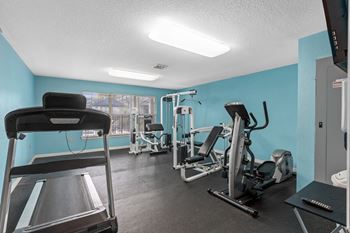The gym has cardio machines and weights in it at the enclave at woodbridge apartments